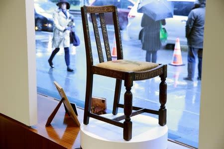 A chair used by British author J.K. Rowling while writing "Harry Potter and the Sorcerer's Stone" and "Harry Potter and the Chamber of Secrets" is shown in the window of Heritage Auctions in New York April 4, 2016. REUTERS/Lucas Jackson -