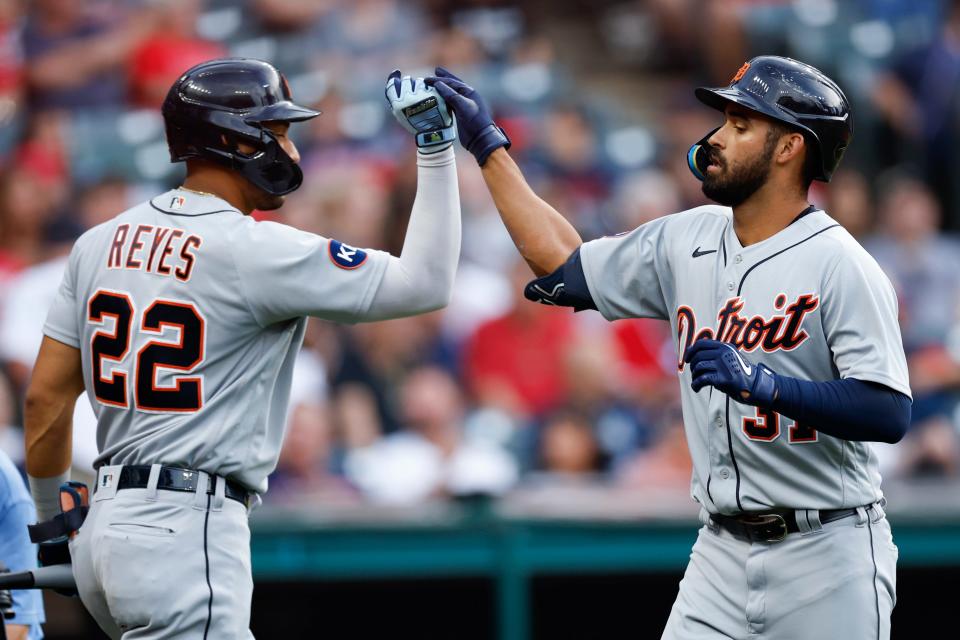 Tigers' Riley Greene (right) celebrates with Victor Reyes after hitting a solo home run off Guardians starting pitcher Zach Plesac during the third inning Friday, July 15, 2022, in Cleveland.