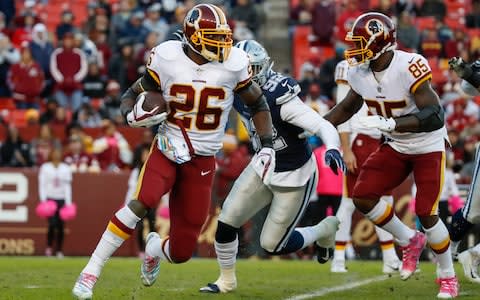 Washington Redskins running back Adrian Peterson (26) carries the ball during the second half of an NFL football game against the Dallas Cowboys, Sunday, Oct. 21, 2018 - Credit: AP