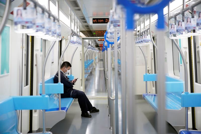 A man wearing a protective mask is seen on a subway in Shanghai