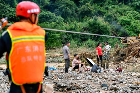 Rescue workers help evacuate stranded villagers affected by flood following heavy rainfall in Heyuan