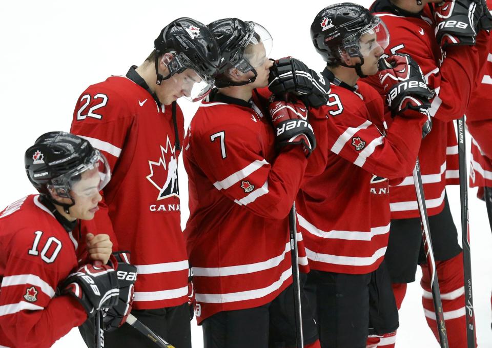 Canada's Charles Hudon (10), Frederik Gauthier (22), Josh Morrissey (7) and Nic Petan react after their loss to Finland in their IIHF World Junior Championship ice hockey game in Malmo, Sweden, January 4, 2014. REUTERS/Alexander Demianchuk (SWEDEN - Tags: SPORT ICE HOCKEY)