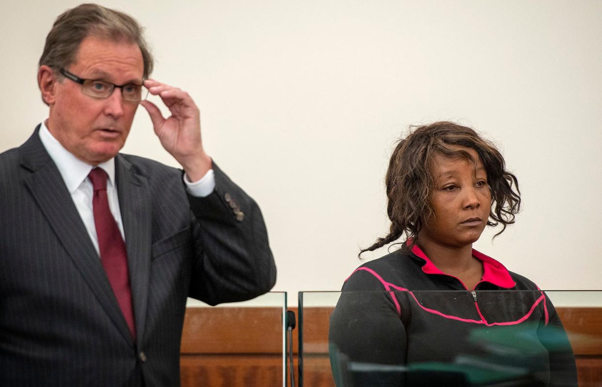 Yvonne Ngoiri, 36, at her arraignment Friday in Worcester Superior Court on charges related to a fatal fire at 2 Gage St. in May. With Ngoiri is her lawyer, Michael S. Hussey.