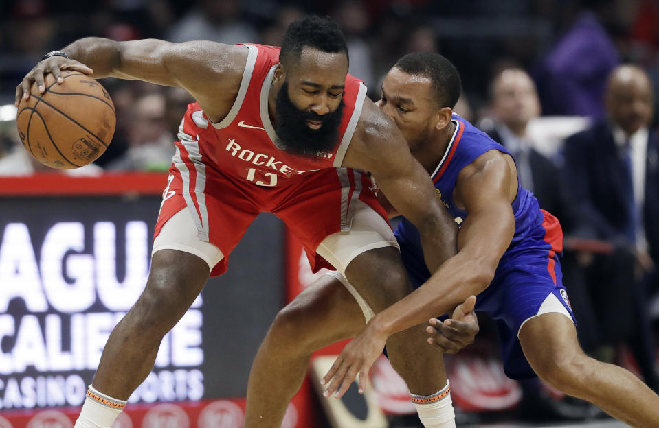 Houston Rockets' James Harden (13) is defended by Los Angeles Clippers' Avery Bradley during the first half of an NBA basketball game Sunday, Oct. 21, 2018, in Los Angeles. (AP Photo/Marcio Jose Sanchez)