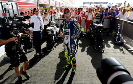 Yamaha MotoGP rider Valentino Rossi of Italy poses for photographers after winning Argentina's MotoGP Grand Prix at the Termas de Rio Hondo International circuit in Termas de Rio Hondo, April 19, 2015. REUTERS/Marcos Brindicci