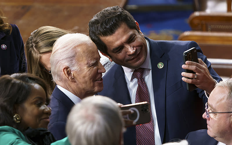 President Biden takes a selfie with Rep. Jimmy Gomez (D-Calif.) after giving his State of the Union address during a joint session of Congress on Feb. 7. <em>Greg Nash</em>