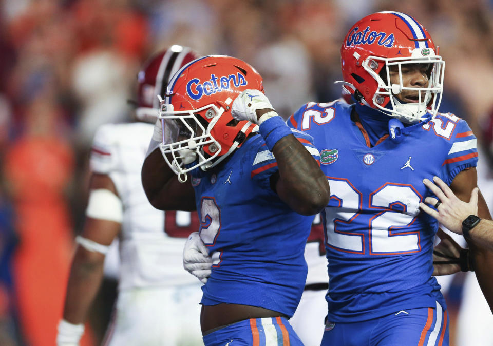 Florida running back Montrell Johnson Jr. (2) celebrates with wide receiver Kahleil Jackson (22) after scoring a touchdown against South Carolina during the second half of an NCAA college football game, Saturday, Nov. 12, 2022, in Gainesville, Fla. (AP Photo/Matt Stamey)