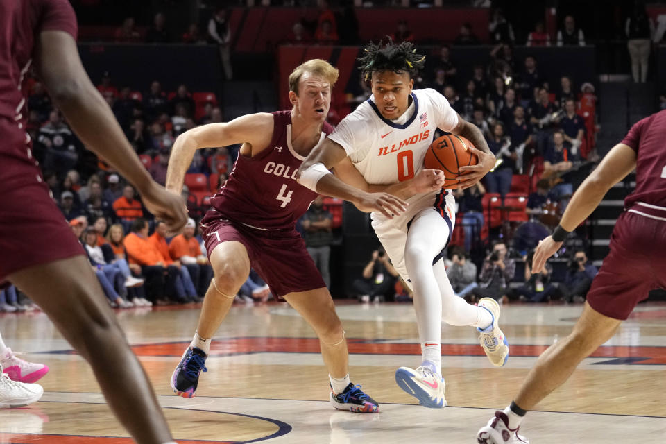 Illinois' Terrence Shannon Jr., right, drives to the basket as Colgate's Ryan Moffatt defends during the first half of an NCAA college basketball game Sunday, Dec. 17, 2023, in Champaign, Ill. (AP Photo/Charles Rex Arbogast)