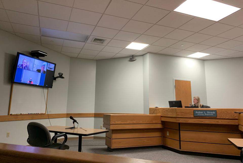 Magistrate Amber Straub, right, arraigns Harold David Haulman III on a first-degree murder charge Wednesday in Calhoun County District Court.