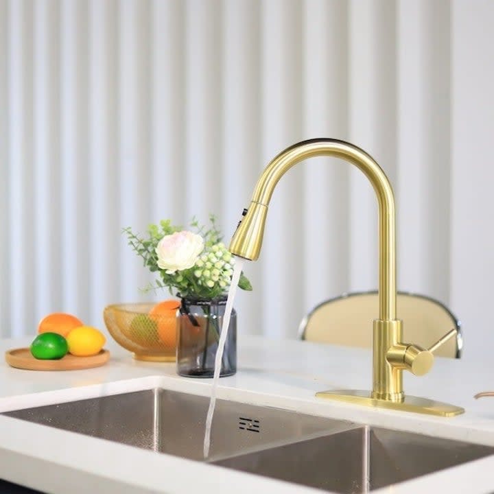 the faucet, in gold, running in a sink