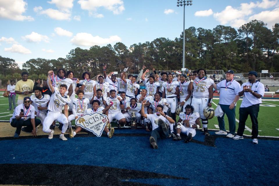 The Bethesda football team poses with the championship trophy after beating Williamsburg Academy to win the SCISA Class 2A state title at Charleston Southern Saturday.