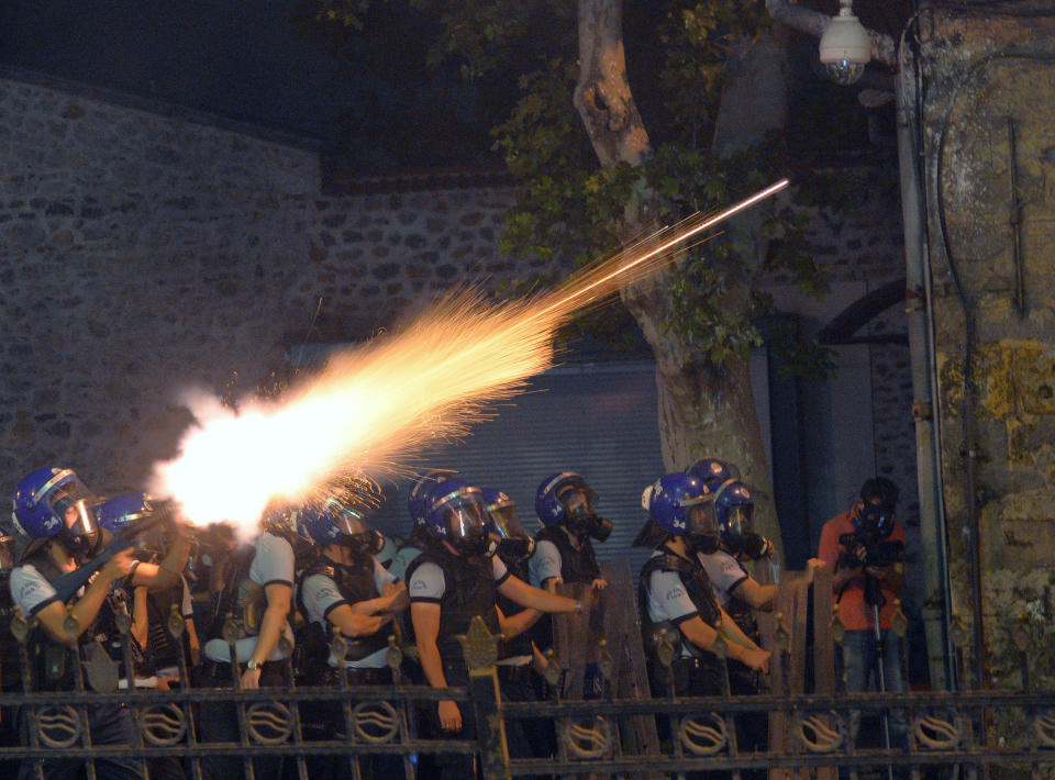 In this photo taken late Saturday, June 1, 2013, riot police fire, as they clash with protestors, near the former Ottoman palace, Dolmabahce, where Turkey's Prime Minister Recep Tayyip Erdogan maintains an office in Istanbul, Turkey. Protests in Istanbul, Ankara and several other Turkish cities appear to have subsided Sunday, after days of fierce clashes following a police crackdown on a peaceful gathering as protesters denounced what they see as Prime Minister Recep Tayyip Erdogan's increasingly authoritarian style. (AP Photo)