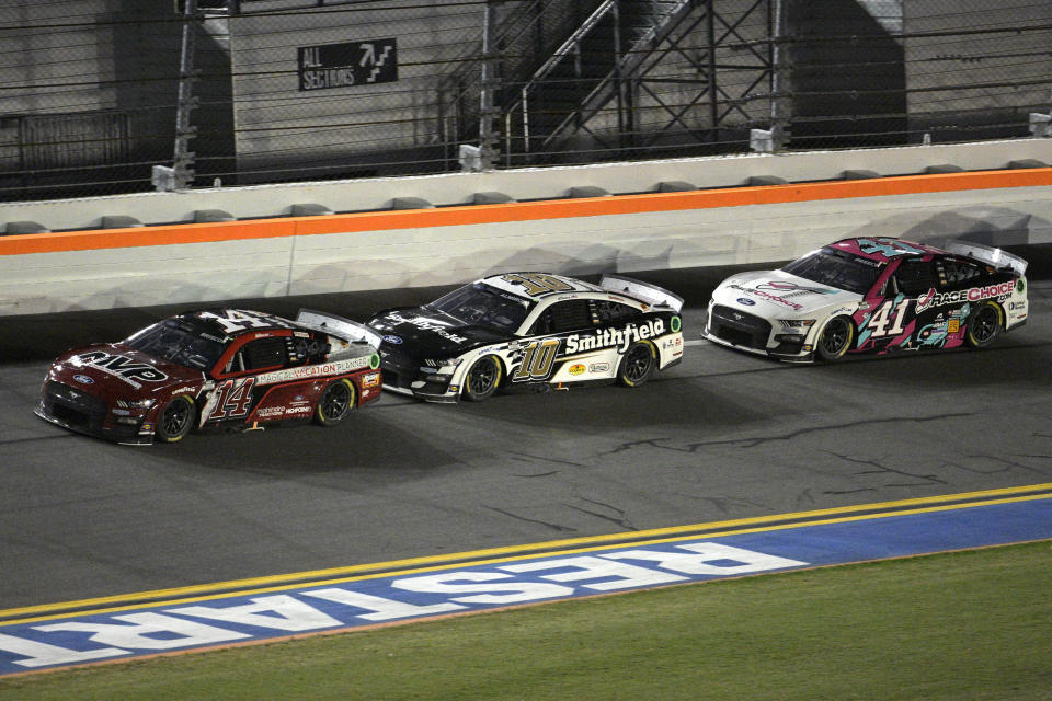 Chase Briscoe (14), Aric Almirola (10) and Ryan Preece (41) head along the front stretch during the NASCAR Cup Series auto race at Daytona International Speedway, Saturday, Aug. 26, 2023, in Daytona Beach, Fla. (AP Photo/Phelan M. Ebenhack)