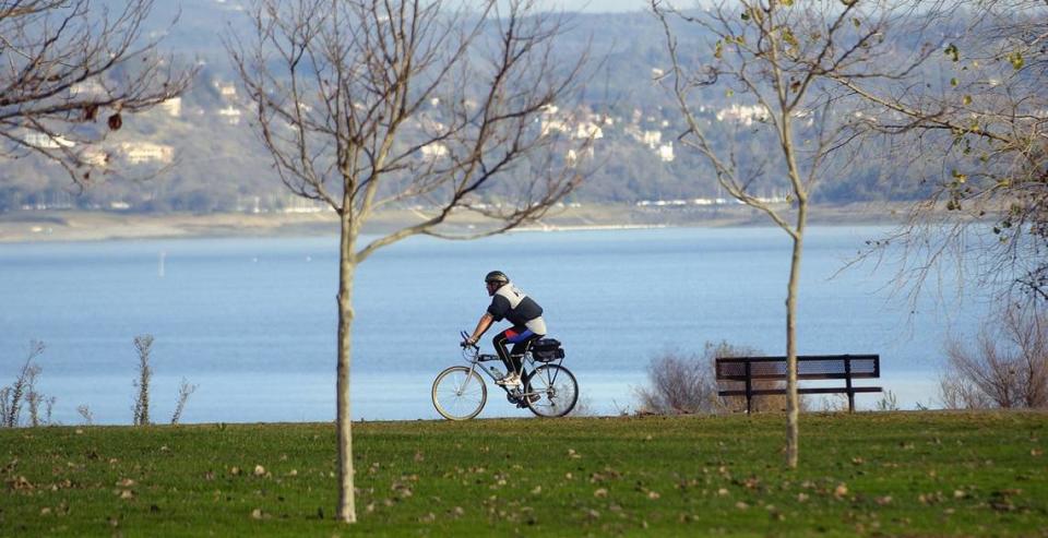 A cyclist rides his bicycle on the bike path along Folsom Lake State Recreation Area in Folsom in 2004..