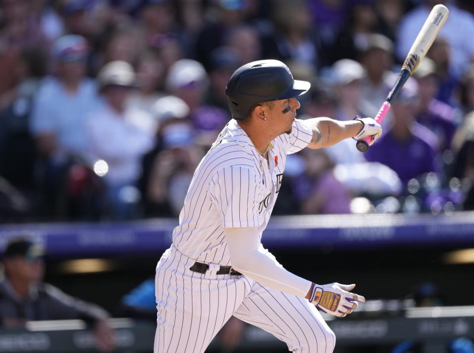 Colorado Rockies pinch-hitter Yonathan Daza follows the flight of his double that drove in three runs off Miami Marlins relief pitcher Cole Sulser in the seventh inning of a baseball game Monday, May 30, 2022, in Denver. (AP Photo/David Zalubowski)