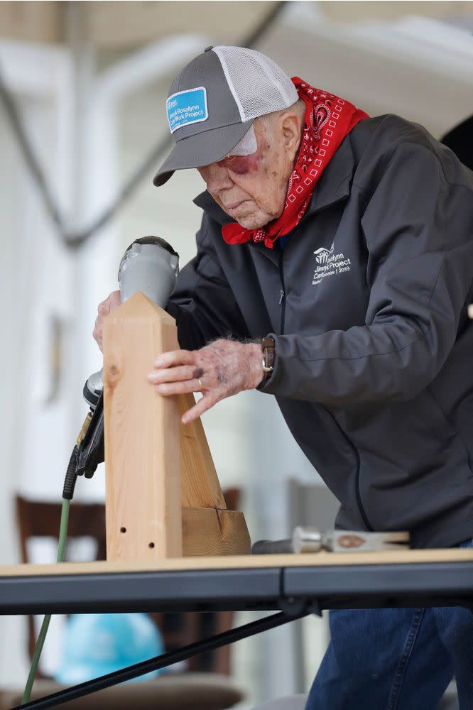President Jimmy Carter helping build homes for Habitat for Humanity, one day after injuring himself in a fall at his home in October. | Mark Humphrey/AP/Shutterstock