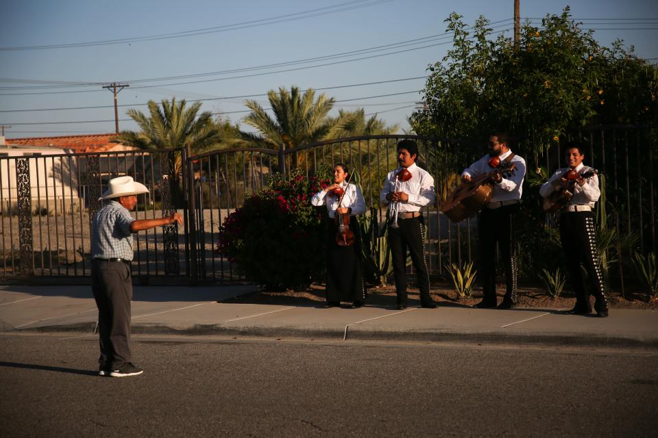 Mariachi Nuevo Amanecer performs while walking through a neighborhood in Mecca, Calif. to spread joy to those at home during the coronavirus pandemic on Sunday, May 17, 2020.