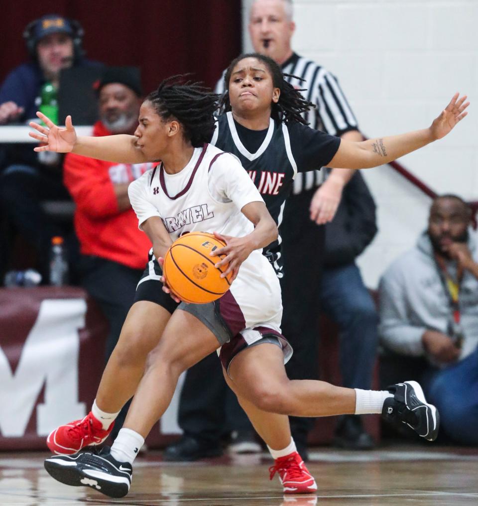 Caravel's Cherish Bryant (front) moves against Ursuline's Chamira Marshall Brothers in the second half of the Bucs' 67-63 win at Caravel on Feb. 8.