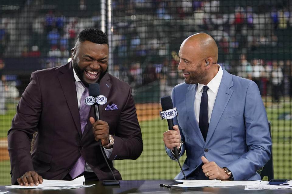 Former Boston Red Sox's David Ortiz laughs as he works with former New York Yankees' Derek Jeter works on set before Game 2 of the baseball World Series between the Arizona Diamondbacks and Texas Rangers Saturday, Oct. 28, 2023, in Arlington, Texas. (AP Photo/Julio Cortez)