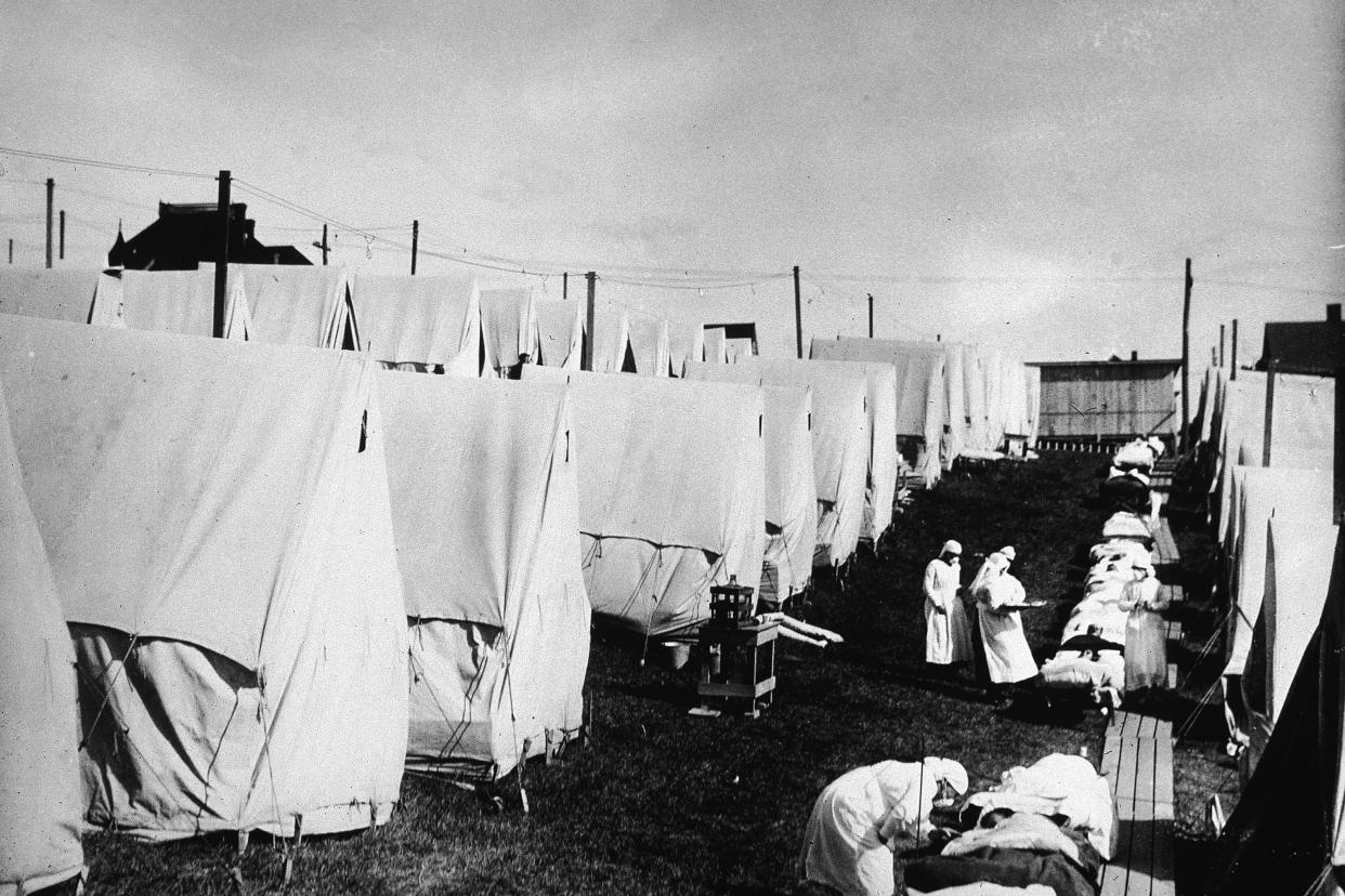 Nurses care for victims of a Spanish influenza epidemic outdoors amidst canvas tents during an outdoor fresh air cure, Lawrence, Massachusetts, 1918