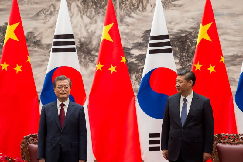 FILE PHOTO: South Korean President Moon Jae-In and Chinese President Xi Jinping are seen during a signing ceremony at the Great Hall of the People in Beijing