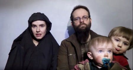 FILE PHOTO A still image from a video posted by the Taliban on social media on December 19, 2016 shows American Caitlan Coleman (L) speaking next to her Canadian husband Joshua Boyle and their two sons.   Courtesy Taliban/Social media via REUTERS/File Photo