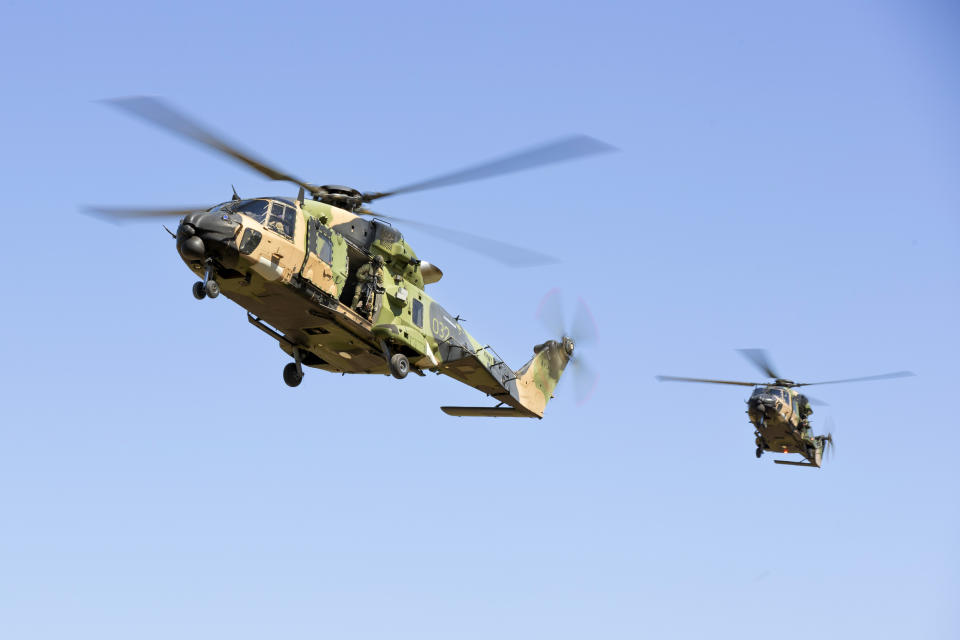 In this photo provided by the Australian Defence Force Australian Army MRH-90 Taipan helicopters prepare to land at Townsville, Australia, May 10, 2023, during Exercise Brolga Run 23. Four air crew were missing after an Australian Army helicopter ditched into waters off the Queensland state coast during joint U.S.-Australian military exercises, officials said, Saturday, July 29, 2023. (LCPL Riley Blennerhassett/ADF via AP)
