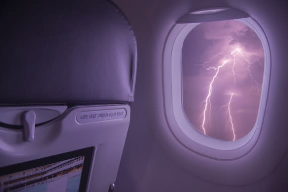 Lightning viewed from inside an airplane cabin