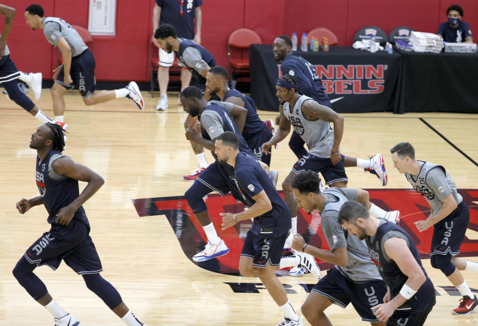 Players run down the court in a training drill. 