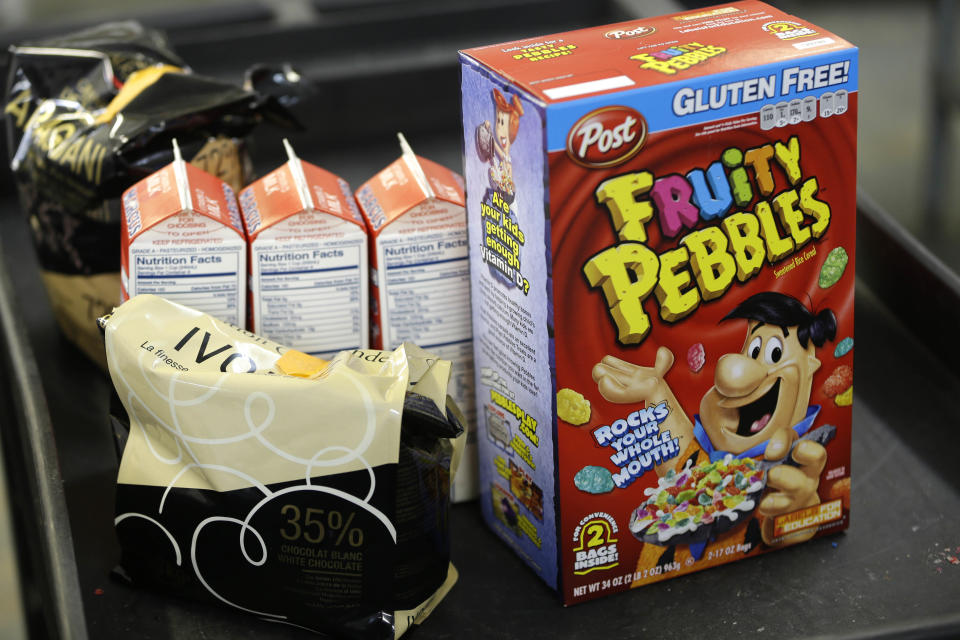 In this Thursday, Feb. 21, 2013 photo, ingredients for fruity cereal milk and other items are prepared for mixing at the Milk Bar kitchen in New York. Cereal is going out of the box. Milk, ice cream, muffin mix and more are being infused with the flavor of the classic childhood treat. (AP Photo/Seth Wenig)