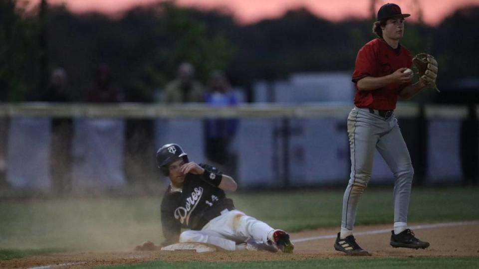 Tates Creek’s Jamison Craig slides safely into third base as he led off the bottom of the fifth inning with a triple against Paul Laurence Dunbar at Tates Creek High School on Wednesday.