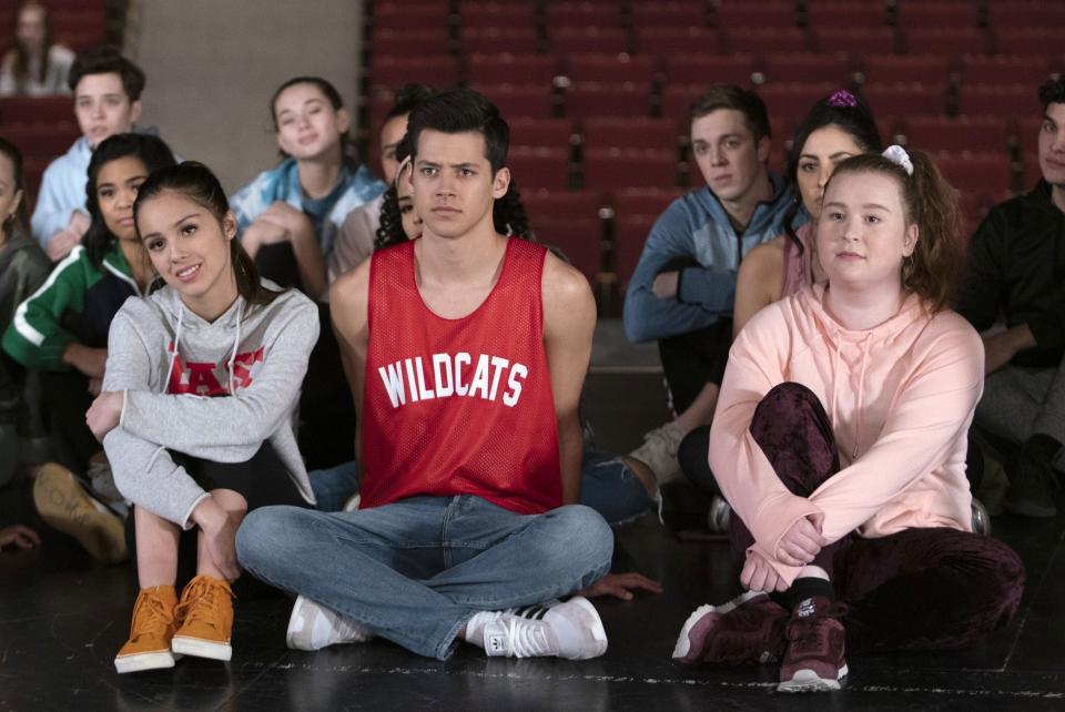 Olivia Rodrigo, Matt Cornett, and Julia Lester sit on the floor during auditions