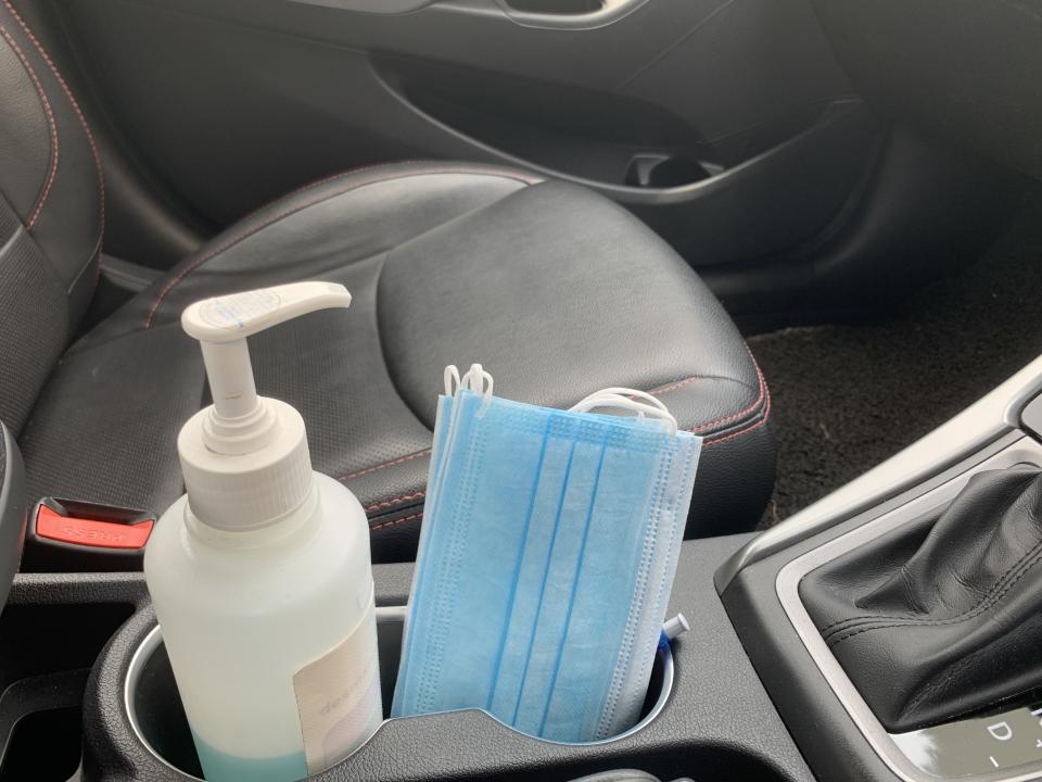 Hand sanitizer and face mask placed in the car