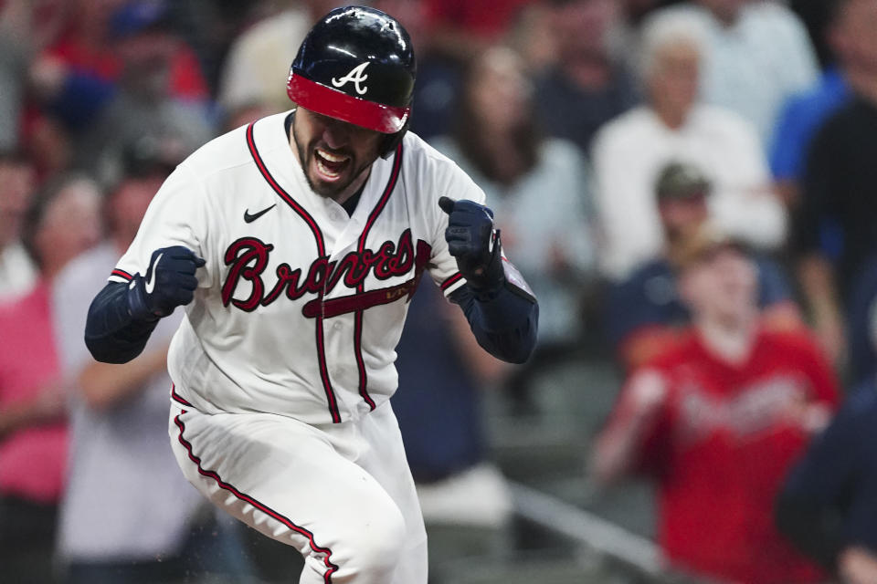 Atlanta Braves' Travis d'Arnaud (16) celebrates his RBI single against the Milwaukee Brewers during the fifth inning of Game 4 of a baseball National League Division Series, Tuesday, Oct. 12, 2021, in Atlanta. (AP Photo/John Bazemore)