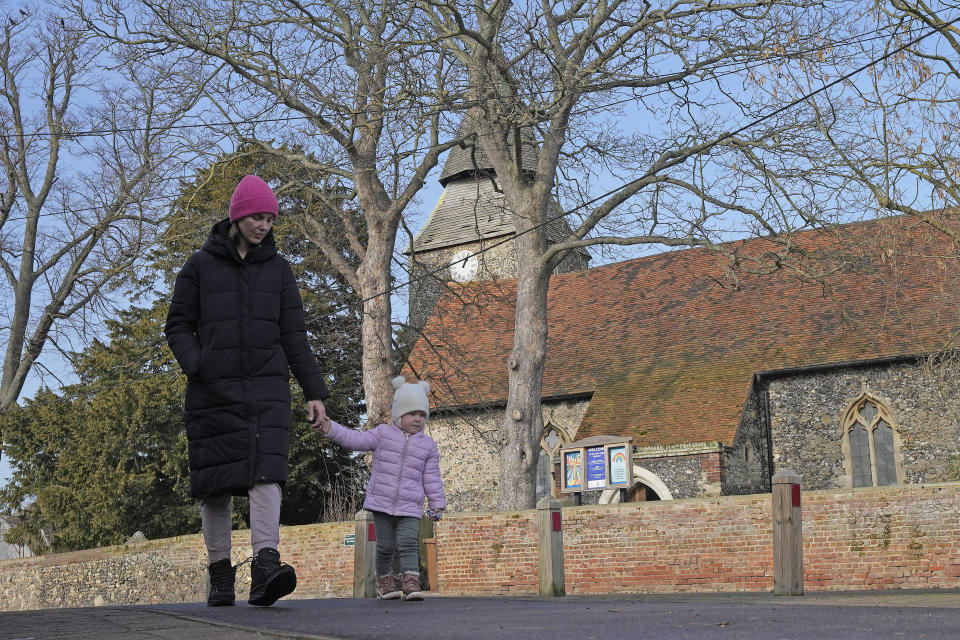 Viktoria Kovalenko, 34, and her daughter Varvara go for a walk in a village in Kent, Thursday, Feb. 9, 2023. Kovalenko chose to come to England not only because it offered her refuge from the war in Ukraine. It was also a chance for her to escape from her harrowing memories of losing her family in a shell attack. (AP Photo/Frank Augstein)