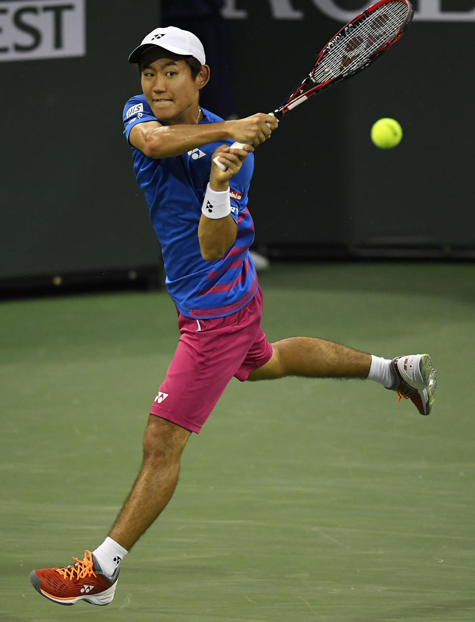 Yoshihito Nishioka, of Japan, returns a shot to Stanislas Wawrinka, of Switzerland, at the BNP Paribas Open tennis tournament, Wednesday, March 15, 2017, in Indian Wells, Calif. (AP Photo/Mark J. Terrill)