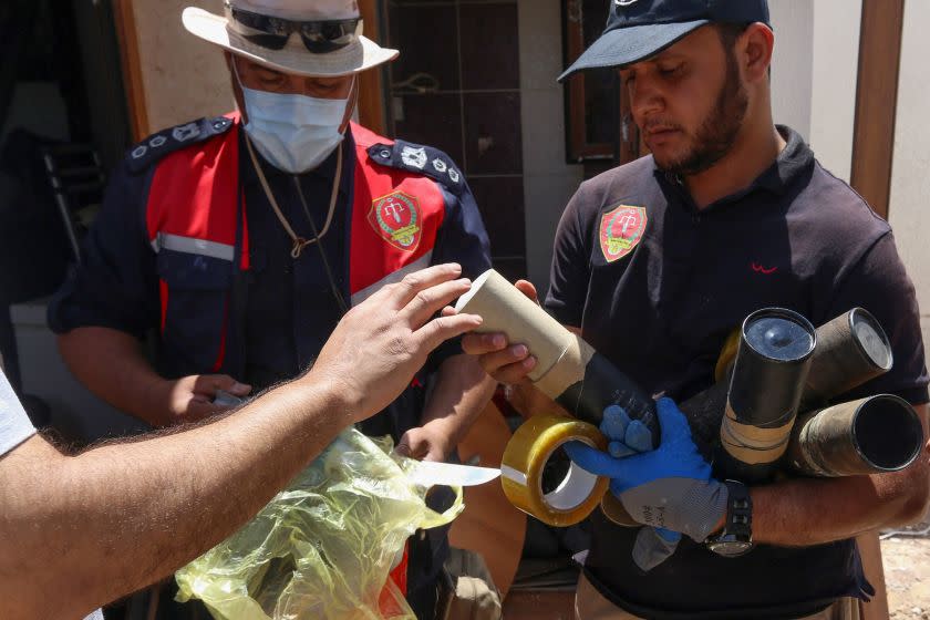 Libyan deminers collect exploded mortar shells found in Tripoli's southern suburb of Mashrou al-Hadba, on June 3, 2020. - Human Rights Watch accused Libyan military strongman Khalifa Haftar's forces of laying Russian landmines in residential southern suburbs of the capital. HRW said the antipersonnel mines discovered in Tripoli in May were "of Soviet and Russian origin". (Photo by - / AFP) (Photo by -/AFP via Getty Images)