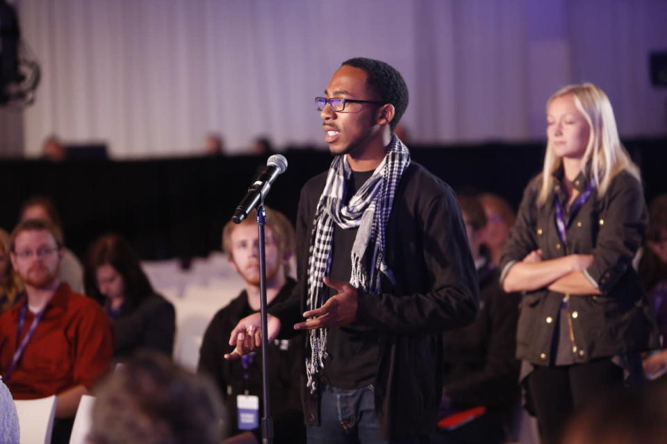 An attendee poses a question to the panel.