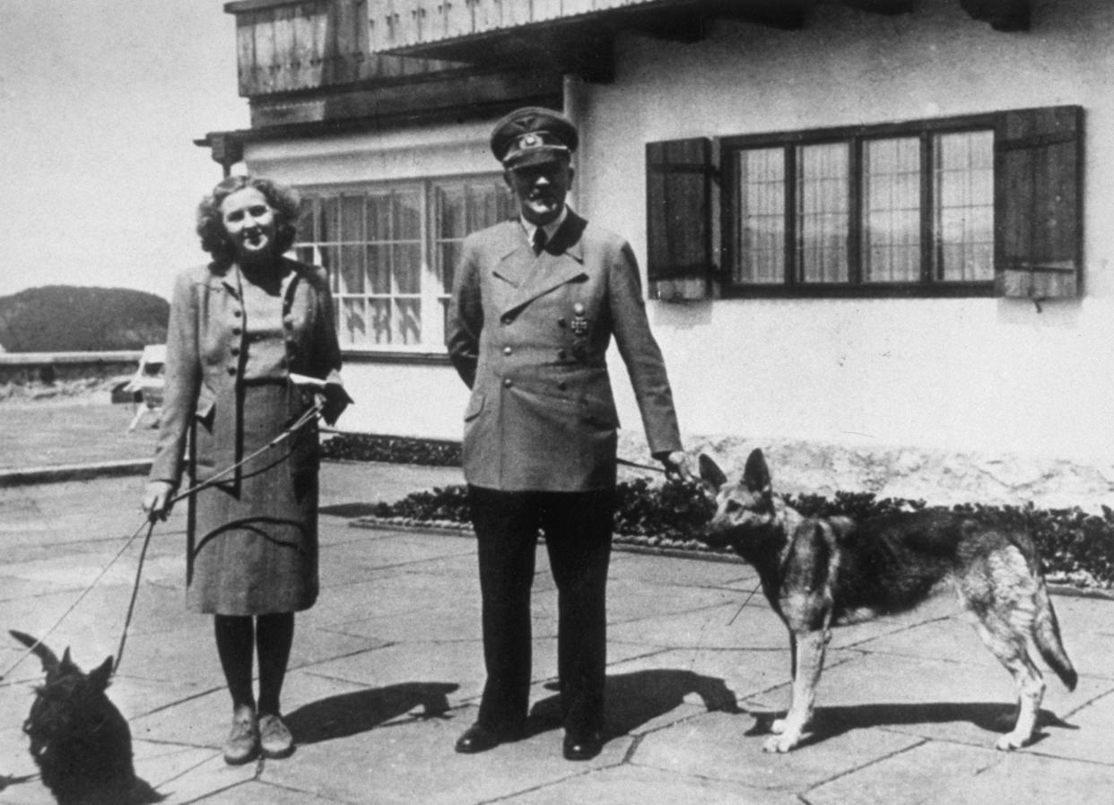 Hitler with Eva Braun, his supposed wife, photographed with their dogs at Berchtesgaden (Getty)