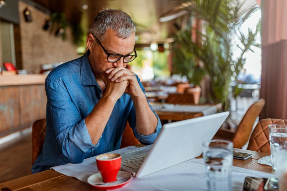 Serious-looking investor with laptop.