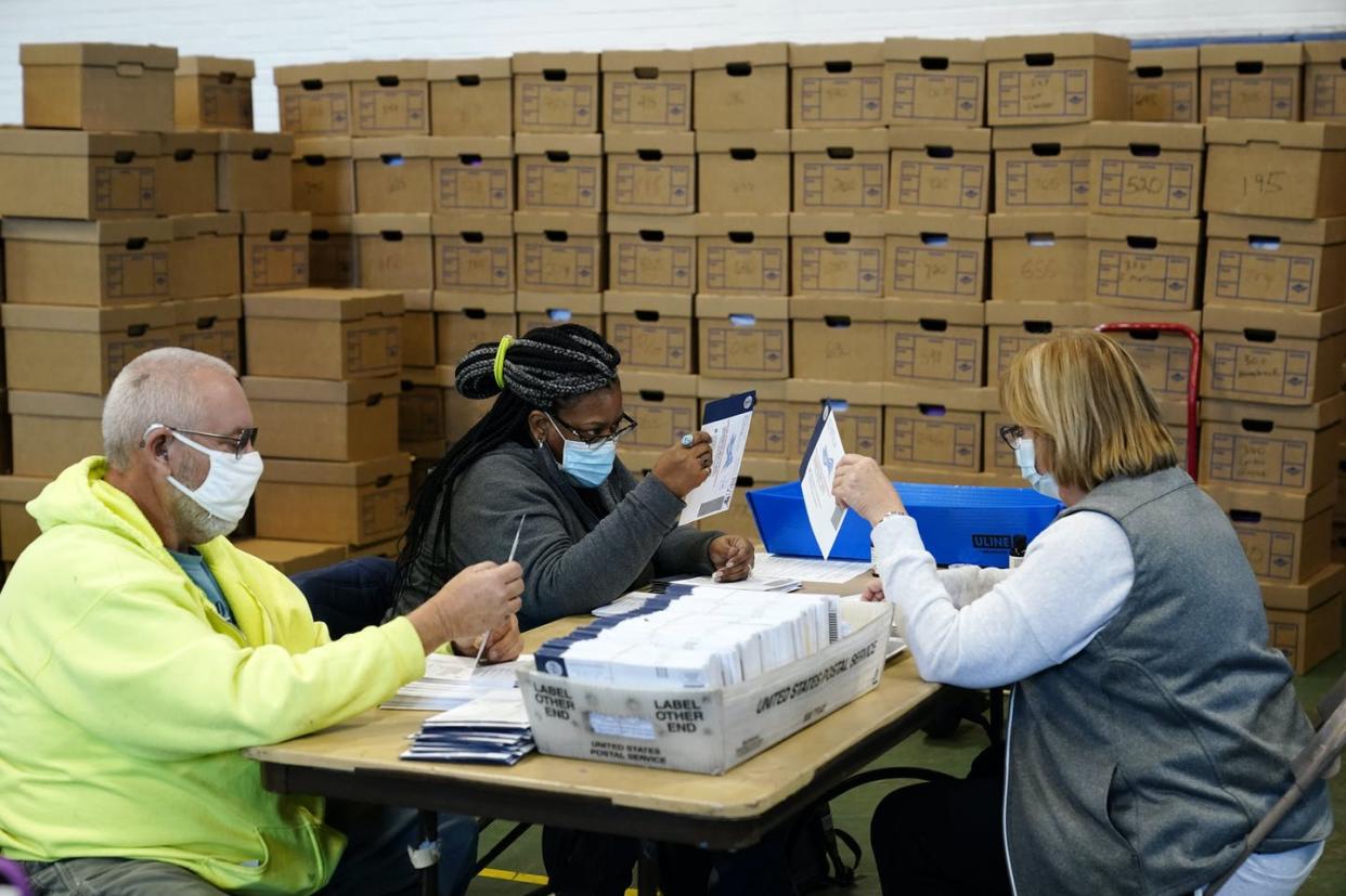 <span class="caption">Mail-in and absentee ballots, like these being processed by election workers in Pennsylvania, are a subject of misinformation spreading across social media.</span> <span class="attribution"><a class="link " href="https://newsroom.ap.org/detail/APTOPIXElection2020PennsylvaniaVoteCounting/54d2d6155b234fd096c55f8c2a4f088b/photo" rel="nofollow noopener" target="_blank" data-ylk="slk:AP Photo/Matt Slocum;elm:context_link;itc:0;sec:content-canvas">AP Photo/Matt Slocum</a></span>