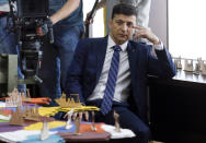 FILE In this file photo taken on Wednesday, Feb. 6, 2019, Ukrainian comedian Volodymyr Zelenskiy, who played the nation's president in a popular TV series, and is running for president in next month's election, is photographed on the set of a movie, in Kiev, Ukraine, For his presidential campaign popular Ukrainian comedian Volodymyr Zelenskiy has literally taken the script from a TV show in which he plays the Ukrainian president. (AP Photo/Efrem Lukatsky, File)