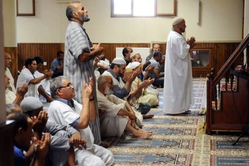 People pray in the Montauban's mosque, southwestern France. French Muslim and Jewish groups were united in outrage Wednesday after two pig heads were dumped at a mosque in a town where an Islamist gunman killed two paratroopers in March