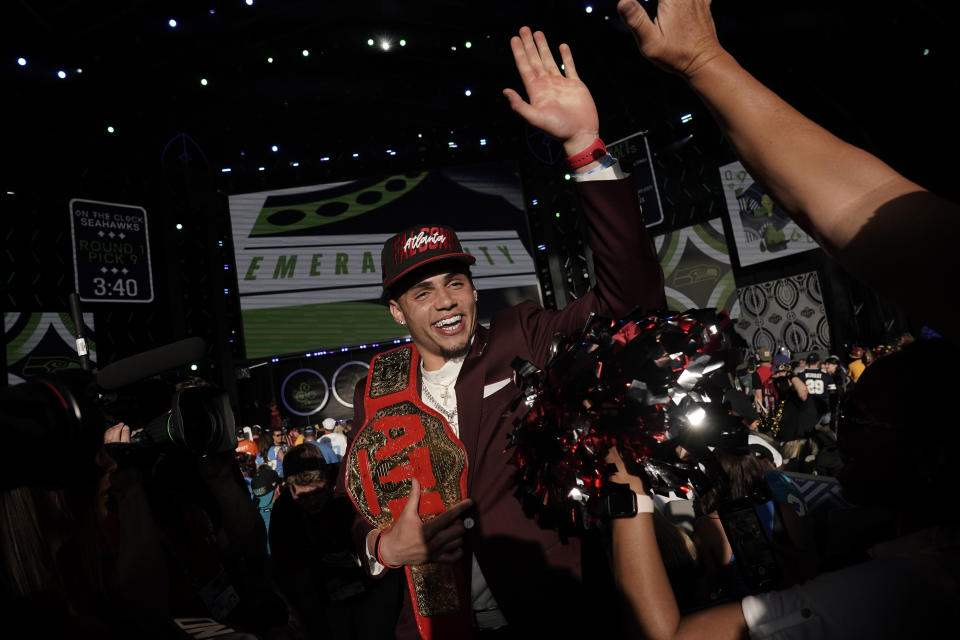 Southern California wide receiver Drake London celebrates with supporters after being chosen by the Atlanta Falcons with the eighth pick of the NFL football draft Thursday, April 28, 2022, in Las Vegas. (AP Photo/Jae C. Hong)