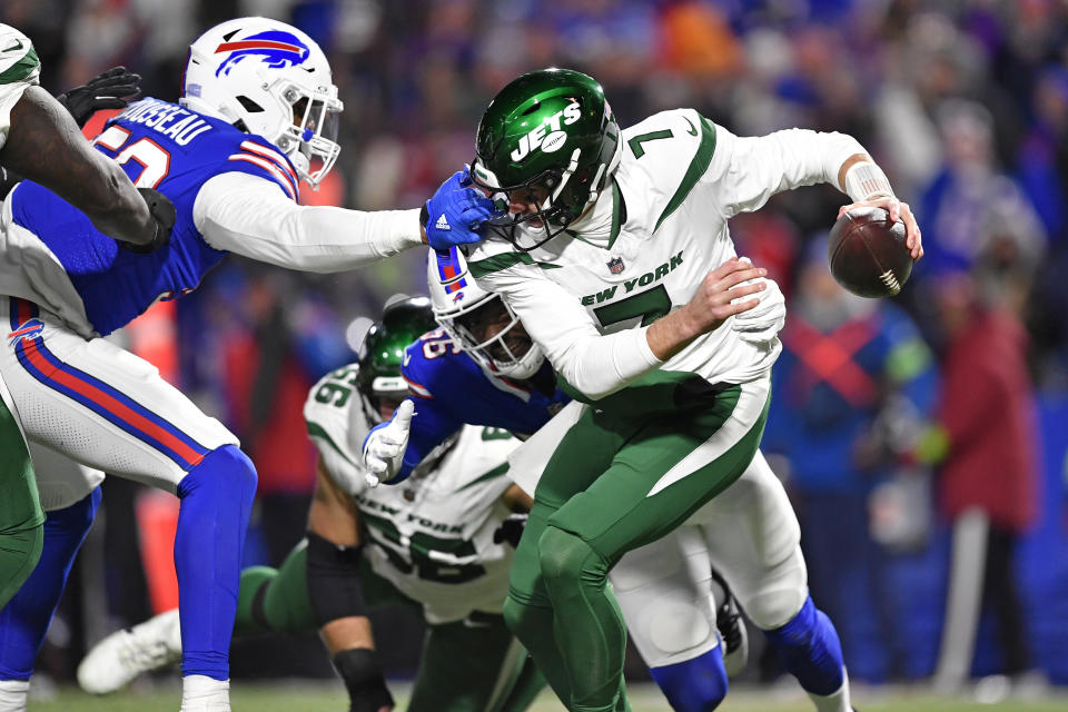 New York Jets quarterback Tim Boyle (7) is sacked by Buffalo Bills defensive end Leonard Floyd, rear, as Buffalo Bills defensive end Greg Rousseau, left, grabs his face mask during the second half of an NFL football game in Orchard Park, N.Y., Sunday, Nov. 19, 2023. No penalty was called on the play. (AP Photo/Adrian Kraus)