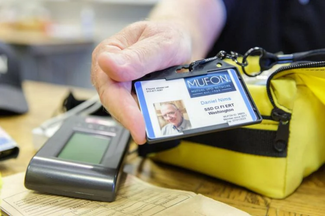 Dan Nims, Walla Walla, holds his Mutional UFO Network identification badge next to his electromagnetic spectrum detector. Steve Lenz/Walla Walla Union-Bulletin