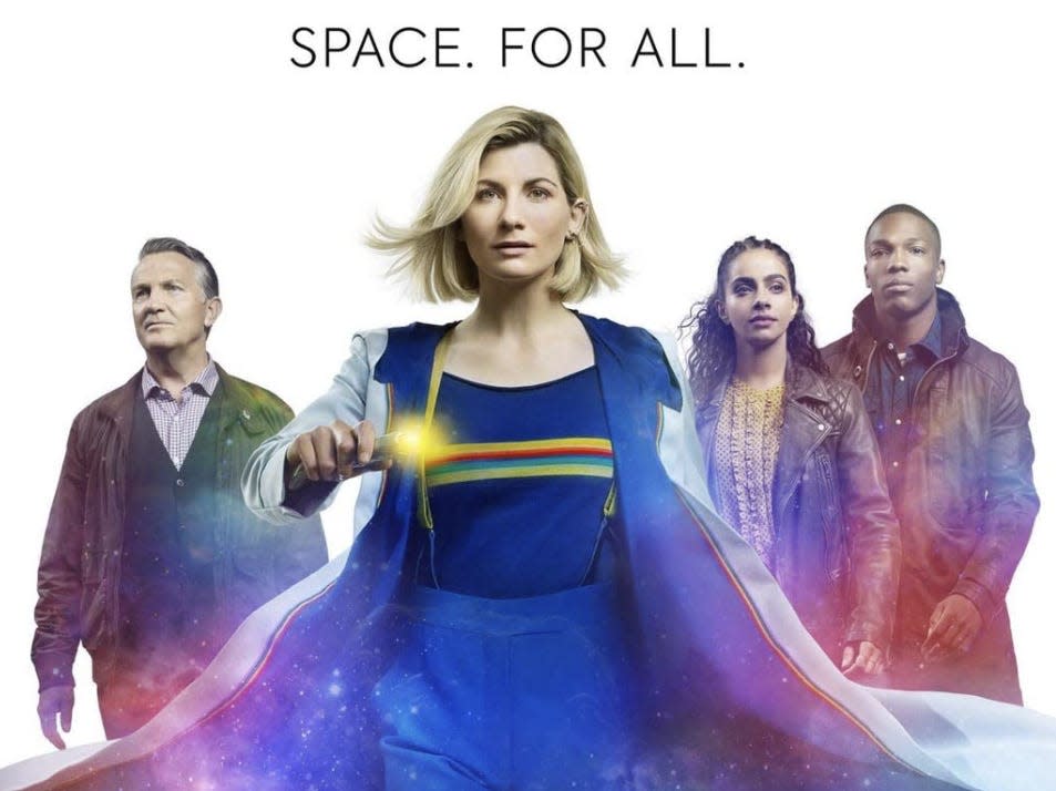 Poster of Jodie in the center in a bright blue costume holding a wand and with her castmates in the background.
