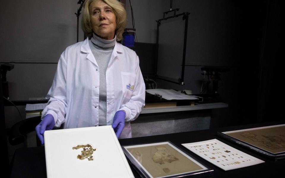 Israel Antiquities Authority conservator Tanya Bitler shows newly discovered Dead Sea Scroll fragments - Sebastian Scheiner /AP