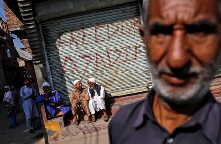 The Wider Image: Barricades and books in restive Kashmir neighbourhood