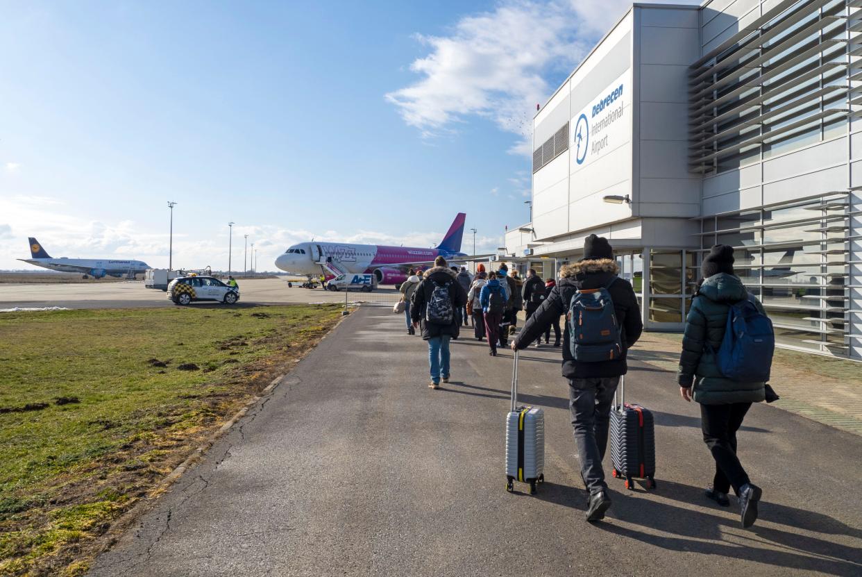 DEBRECEN - JANUARY 21: Passengers walking to the airplane before flight by Wizz Air airline in Debrecen on January 21. 2022 in Hungary